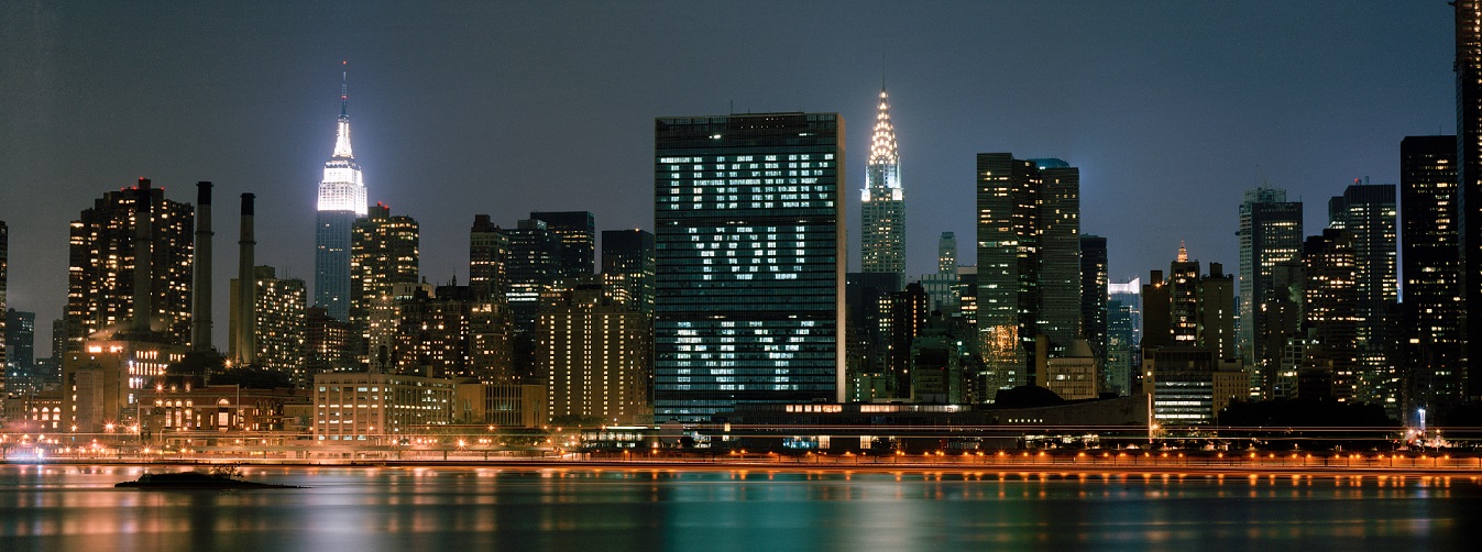 United Nations Secretariat building in New York, seen from East River. Its windows are illuminated with the words 'THANK YOU NY'
