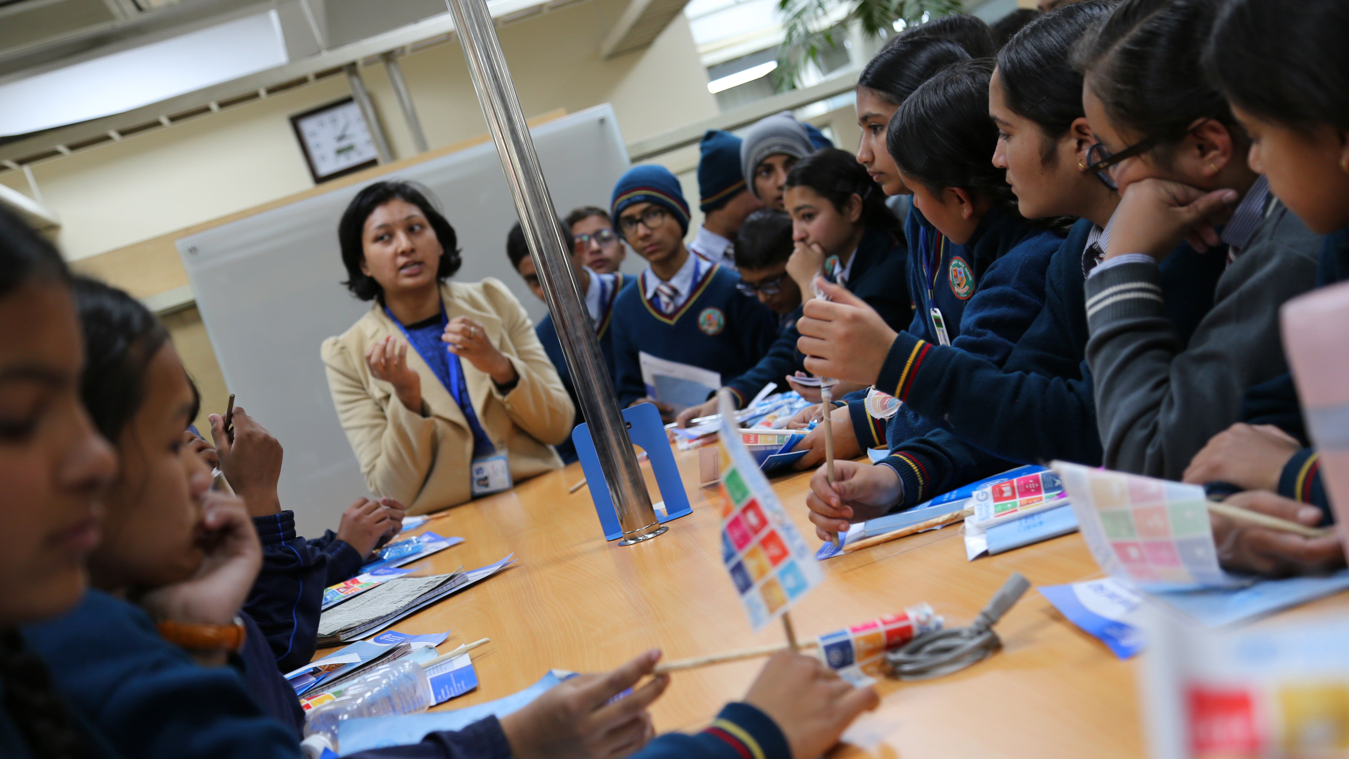 Photo: UNIC Kathmandu A woman lectures a group of people