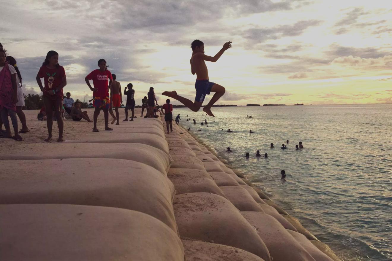 children jumping in sea